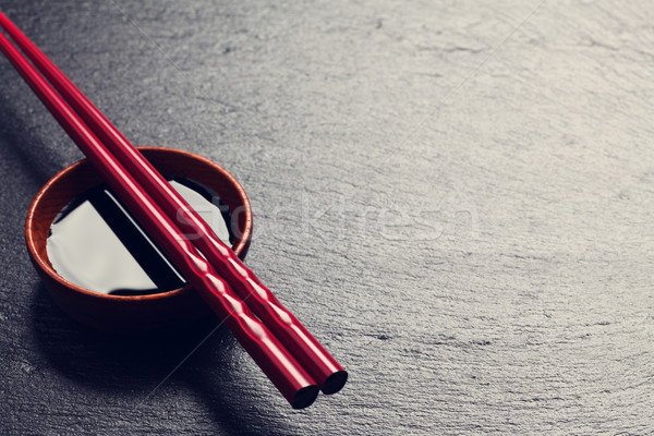 Japanese sushi chopsticks over soy sauce bowl Stock photo © karandaev