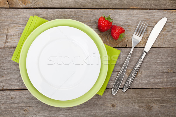 Empty plate with silverware and ripe strawberry Stock photo © karandaev