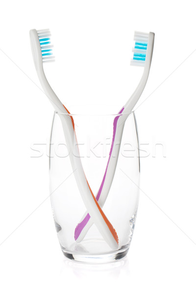 Two toothbrushes in a glass Stock photo © karandaev
