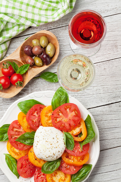 Caprese salad with tomatoes, basil and mozzarella with wine Stock photo © karandaev