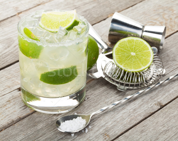 Stock photo: Classic margarita cocktail with salty rim on wooden table