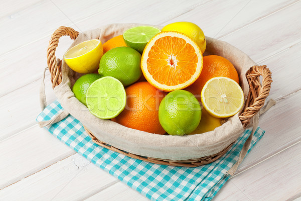 Stock photo: Citrus fruits in basket. Oranges, limes and lemons