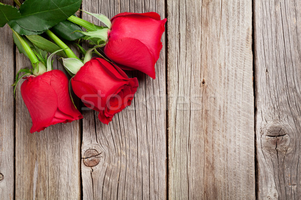 Red roses over wood Stock photo © karandaev