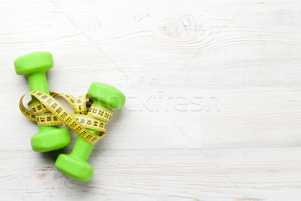 Stock photo: Dumbells and tape measure