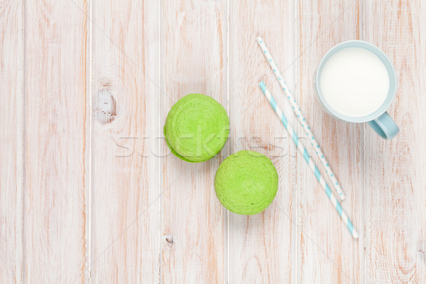 Colorful macarons and cup of milk Stock photo © karandaev