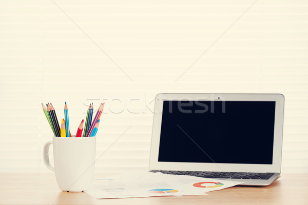 Office workplace with laptop, reports and pencils Stock photo © karandaev