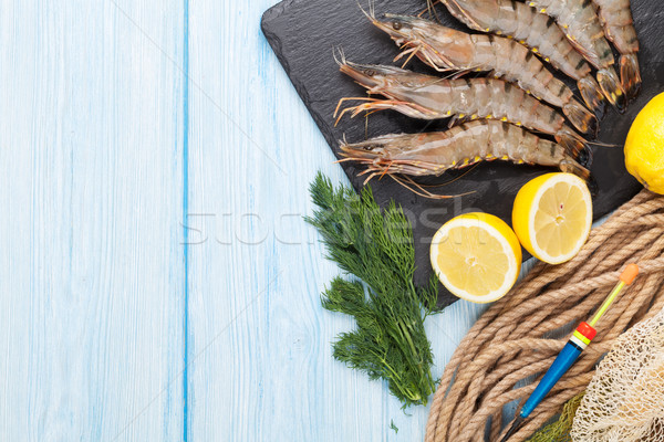 Fresh raw tiger prawns and fishing equipment Stock photo © karandaev