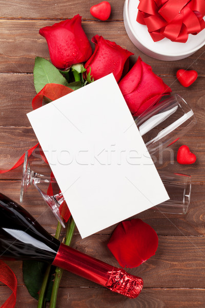 Red roses, champagne and greeting card Stock photo © karandaev