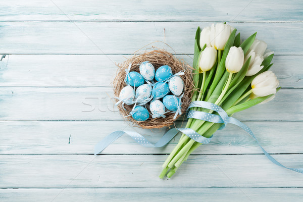 Easter eggs and white tulips Stock photo © karandaev