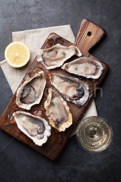 Oysters with lemon and white wine Stock photo © karandaev