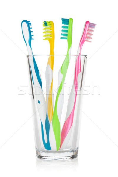 Colorful toothbrushes in glass Stock photo © karandaev