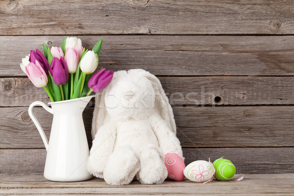 Rabbit toy, easter eggs and colorful tulips Stock photo © karandaev