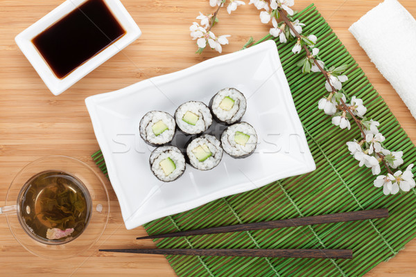 Japanese roll with cucumber and fresh sakura branch Stock photo © karandaev
