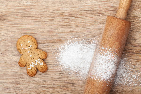 Rolling pin with flour and gingerbread cookie on wooden table Stock photo © karandaev