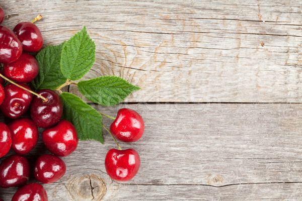 Ripe cherries on wooden table Stock photo © karandaev