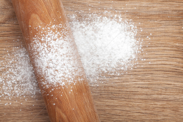 Rolling pin with flour on wooden table Stock photo © karandaev