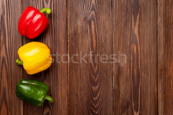 Colorful bell peppers on wooden table Stock photo © karandaev