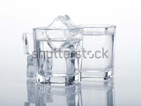 Három olvad jégkockák üveg asztal fény Stock fotó © karandaev