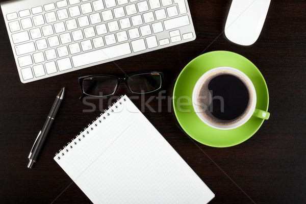 Office desk table with computer, supplies, coffee and glasses Stock photo © karandaev