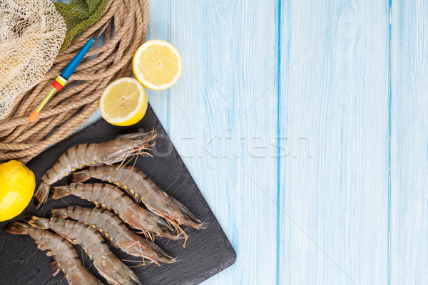 Fresh raw tiger prawns and fishing equipment Stock photo © karandaev