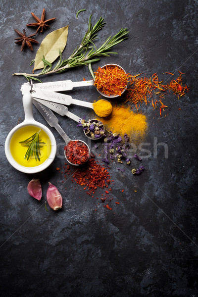 Herbs and spices over black stone Stock photo © karandaev