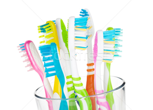 Colorful toothbrushes in glass Stock photo © karandaev