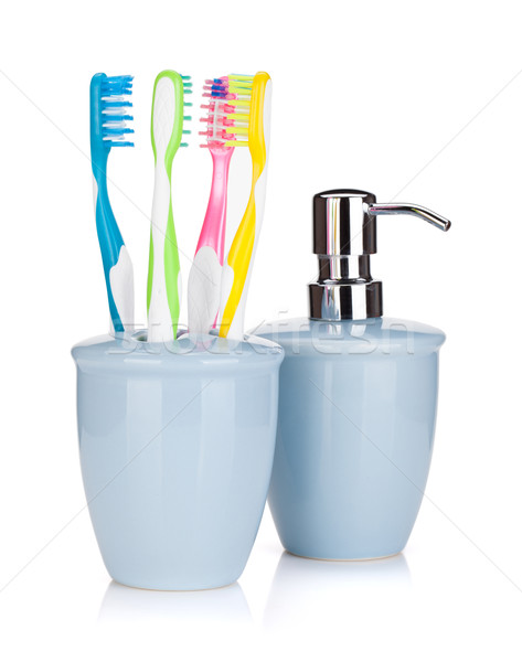 Four colorful toothbrushes and liquid soap Stock photo © karandaev