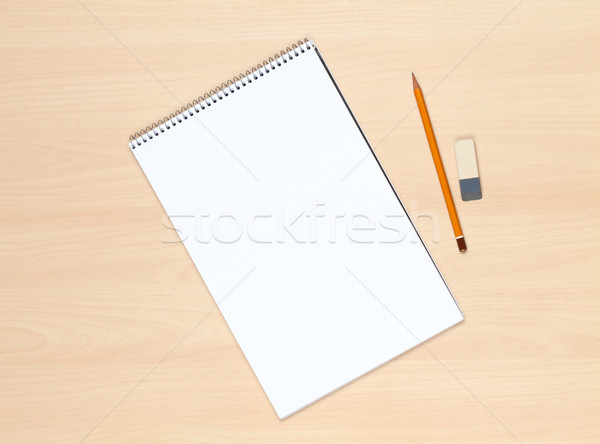 Blank notepad, pencil and eraser on the wooden table Stock photo © karandaev