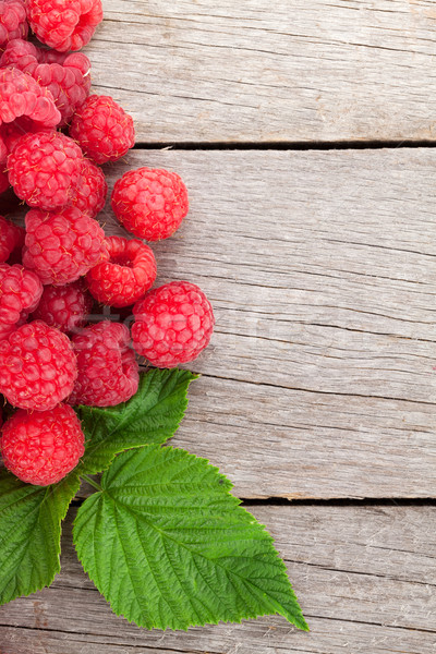 Fresh ripe raspberries on wooden table Stock photo © karandaev