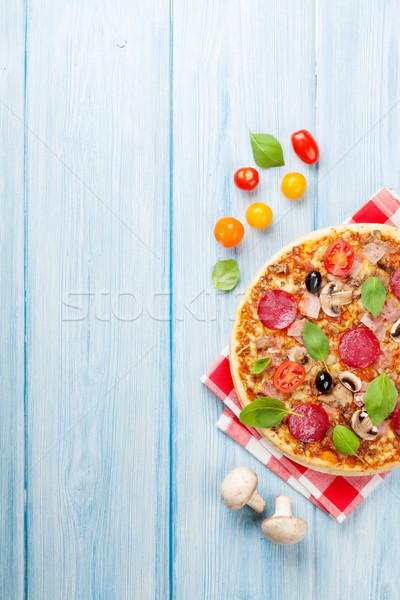 Stock photo: Italian pizza with pepperoni, tomatoes, olives and basil