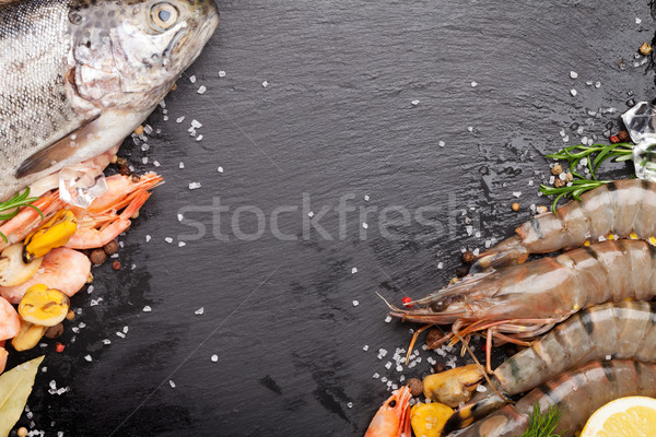 Stock photo: Fresh raw sea food with spices on black stone