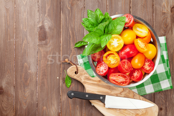Fresh colorful tomatoes and basil in colander Stock photo © karandaev