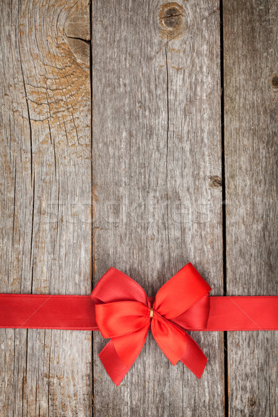 Wooden background with red bow and ribbon Stock photo © karandaev