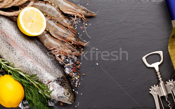 Fresh raw sea food with spices and white wine bottle Stock photo © karandaev