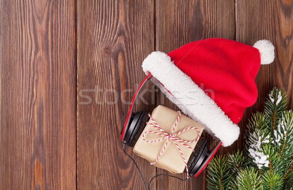 Christmas gift box with headphones and santa hat Stock photo © karandaev