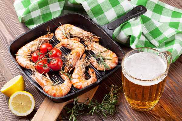 Grilled shrimps on frying pan and beer Stock photo © karandaev