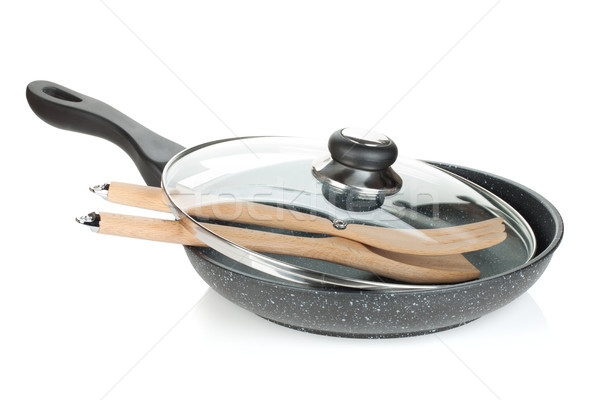 Frying pan with glass cover and wooden utensils Stock photo © karandaev