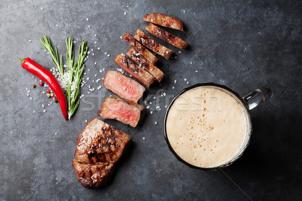 Grilled striploin steak and beer Stock photo © karandaev