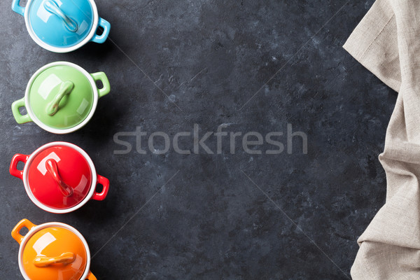 Colorful saucepans on stone Stock photo © karandaev