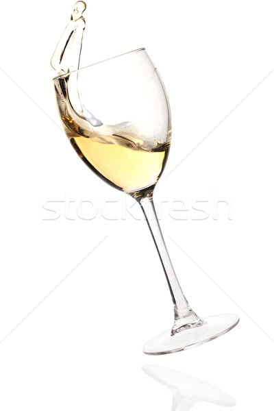 Splashing white wine in a falling glass Stock photo © karandaev