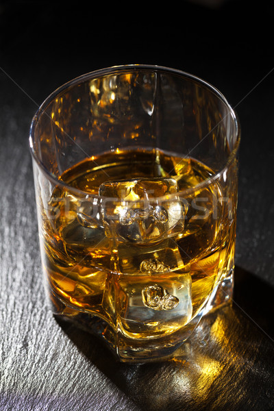 üveg whiskey jég fekete kő asztal Stock fotó © karandaev