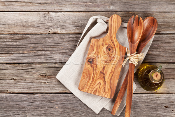 Cooking utensils and olive oil on wooden table Stock photo © karandaev