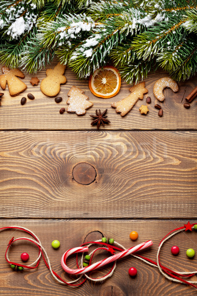 Christmas wooden background with snow fir tree, spices, gingerbr Stock photo © karandaev