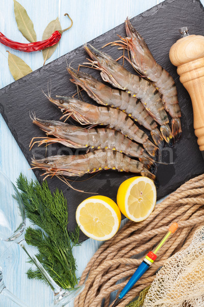 Fresh raw tiger prawns and fishing equipment Stock photo © karandaev