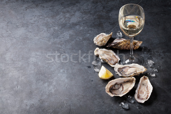 Oysters with lemon and white wine Stock photo © karandaev