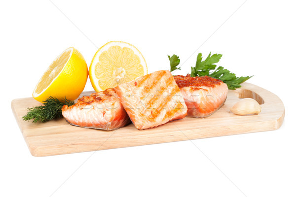 Grilled salmon with lemon and herbs on cutting board Stock photo © karandaev