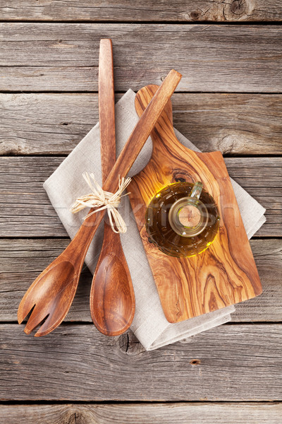 Cooking utensils and olive oil on wooden table Stock photo © karandaev
