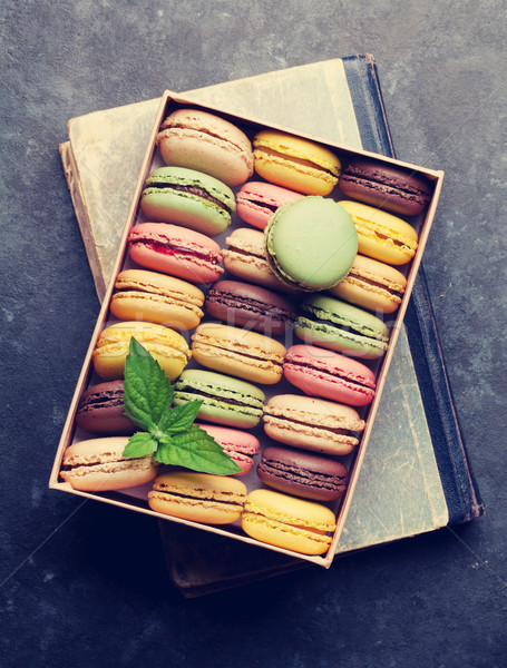 Stock photo: Colorful macaroons in a box over book