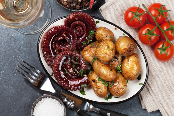 Grilled octopus with small potatoes and wine Stock photo © karandaev