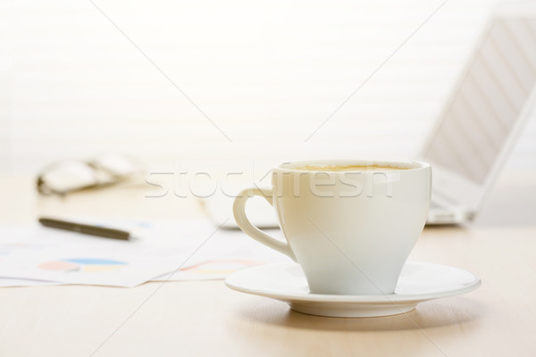 Office workplace with coffee, laptop and supplies Stock photo © karandaev